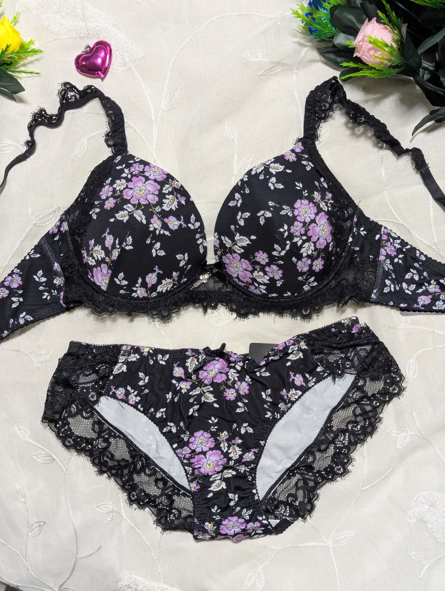 Black floral lingerie set on a light background